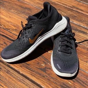 Nike sneakers with gold swoosh